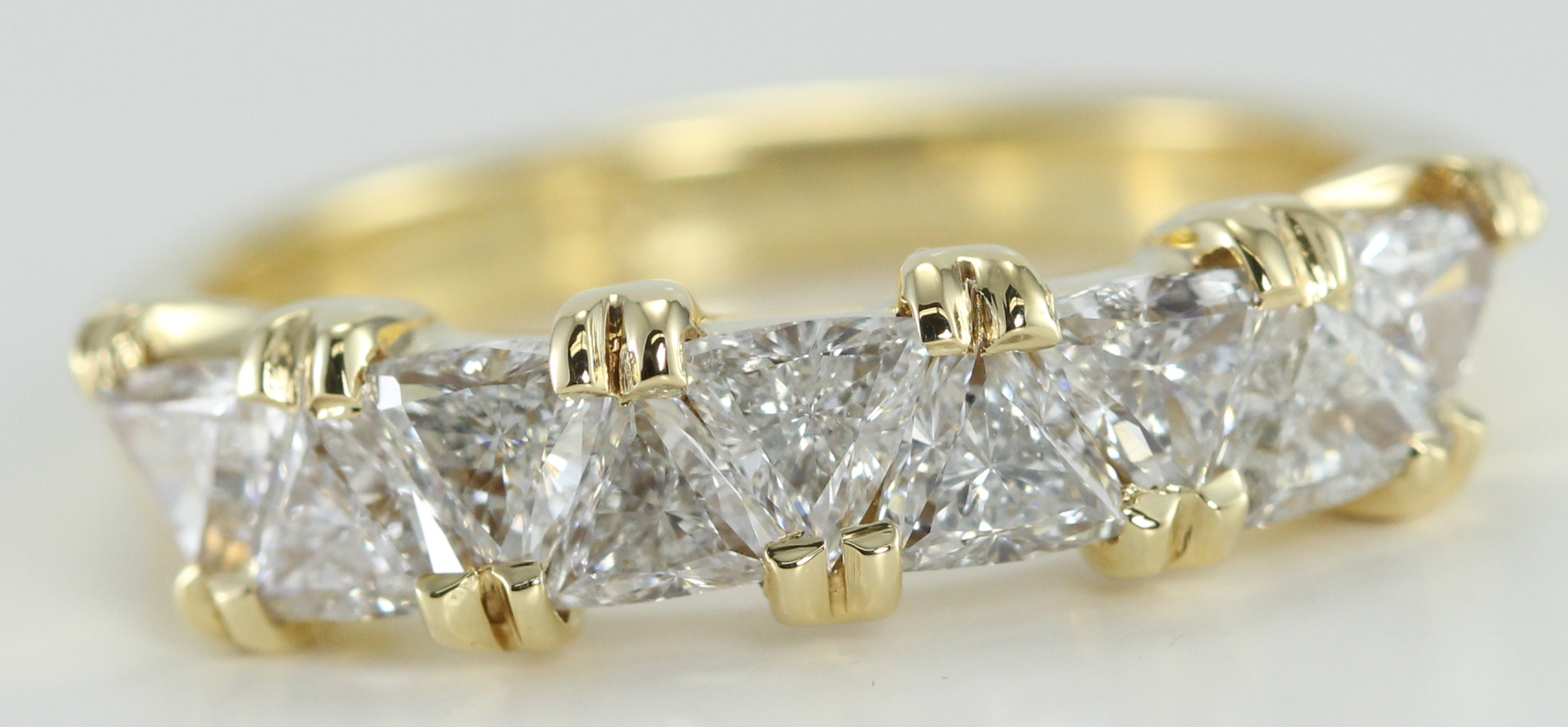 9 Stone H Color, VS Clarity Triangle Cut Diamond Wedding Band set in 18K Yellow Gold. Total Carat Weight: 1.34 Ct.