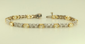 A 14k White and Yellow Gold link diamond bracelet with millennial and round cut diamonds