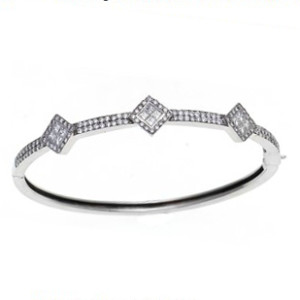 An 18 karat white gold bangle bracelet set with Princess and Round cut diamonds