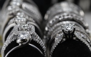 A row of 14 karat white gold rings set for display.