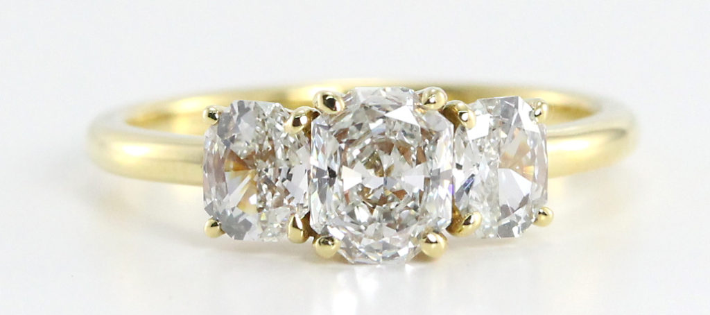 Radiant cut three stone diamond engagement ring 